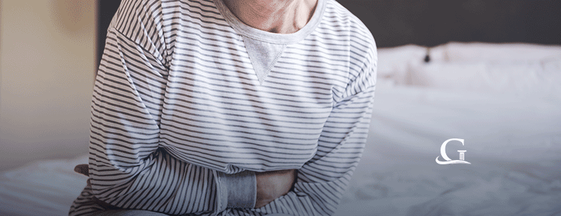 Elderly Woman Experiencing Stomach Pain Stock Photo