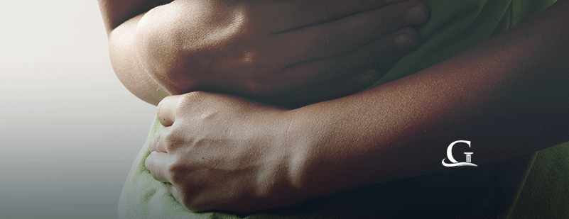 Female Experiencing Abdominal Pain Stock Photo