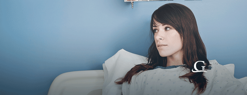 Female Patient In A Hospital Bed Stock Photo