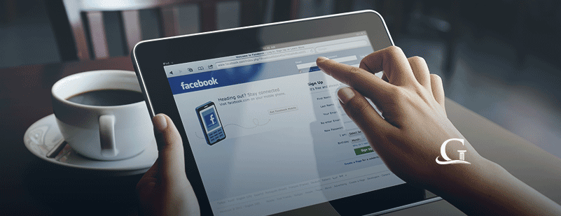 Female Browsing Facebook On An IPad Stock Photo