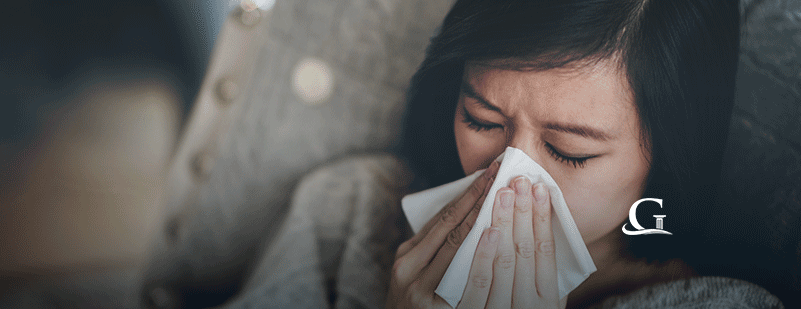 Sick Young Woman Blowing Her Nose Stock Photo