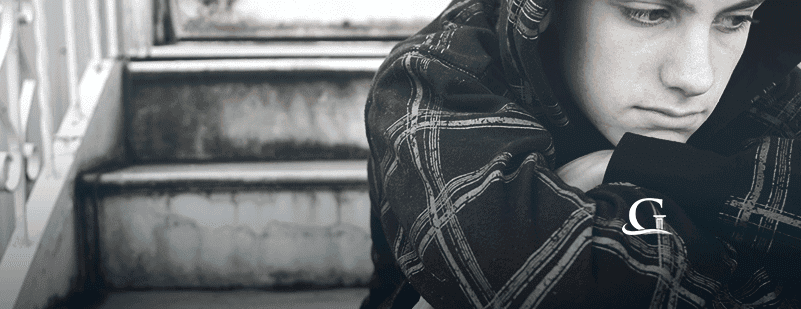 Male Teenager With Worried Look On His Face Stock Photo