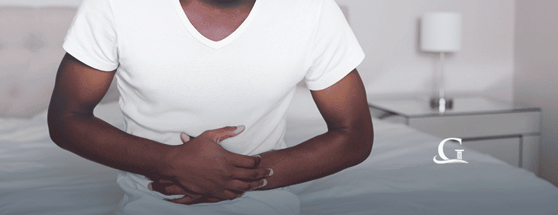 Male Experiencing Stomach Pain Stock Photo