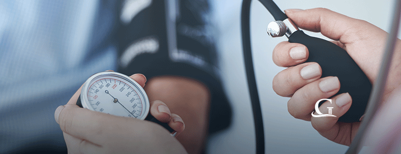 Nurse Taking Male Patient's Blood Pressure Stock Photo