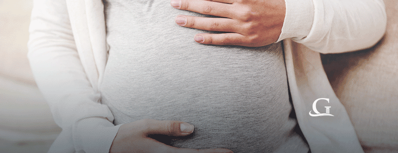 Pregnant Woman Holding Stomach Stock Photo