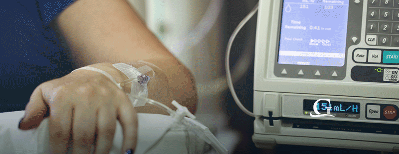 Female Patient Hooked Up To An IV Drip Stock Photo