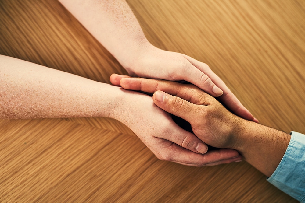 hands comforting after the loss of a loved one